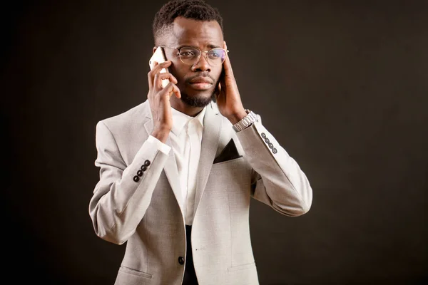 Trabajador de oficina serio está escuchando a su compañero por teléfono con mucha atención — Foto de Stock