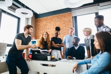 guy with beard and moustache motivating workers to start up risky business clipart