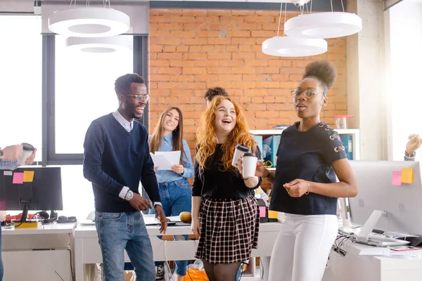 Jóvenes gerentes sonrientes tomando té en tiempo de descanso en el lugar de trabajo — Foto de Stock