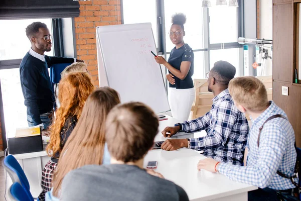 Afrikanische Leiterin stellt Marketingprojekt für aktives Team vor. — Stockfoto