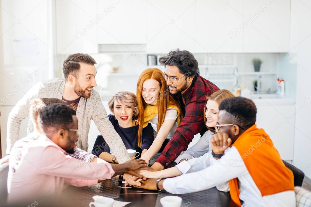 joyful conneting hands together in the modern office canteen