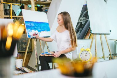 Kadın sanatçı resmini şövale onun atölyesinde yağlı boya ile resim