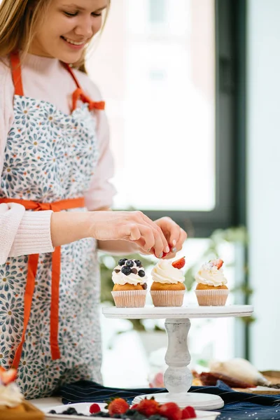 Panadería Chef mujer decoración cupcakes en cocina acogedora —  Fotos de Stock