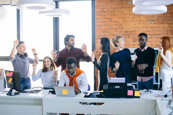 mixed race office worrkers are distracting their employee from work