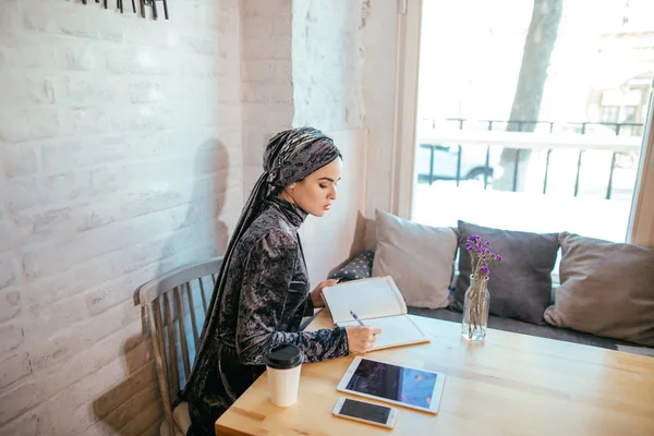 Mulher muçulmana trabalhando no café — Fotografia de Stock