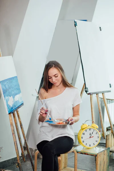 Zeit zum Schaffen. attraktive Frau posiert mit vollem Gesicht, während sie eine Meereslandschaft malt — Stockfoto