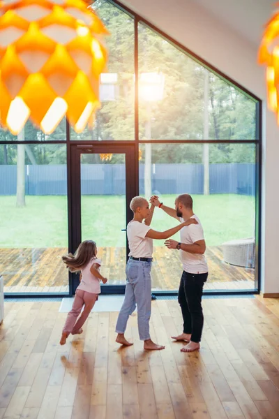 Happy active family dancing in room — Stock Photo, Image