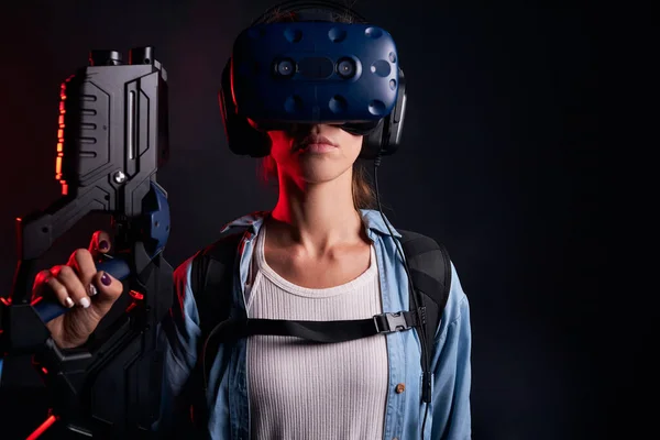 Female playing VR shooter game with virtual reality gun and glasses — Stock Photo, Image