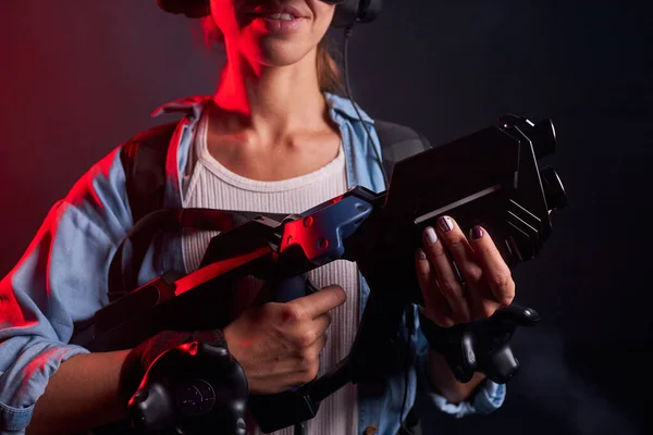 Cropped female playing VR shooter game with virtual reality gun and glasses — Stock Photo, Image