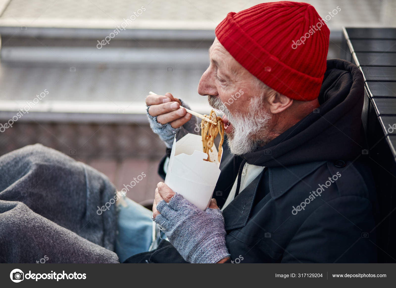 Old-aged sitting walking street and hungrily eating Stock Photo ©ufabizphoto 317129204