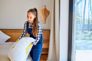 Üniformalı gülümseyen temizlikçi temizlik işinde iyi eğlenceler.