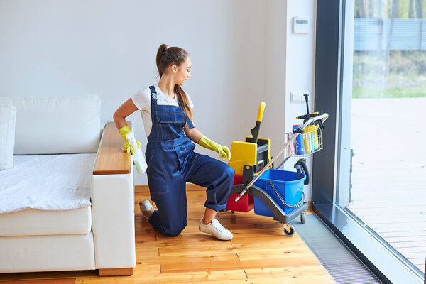 Portrait of young caucasian woman cleaning up room
