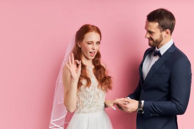 Funny positive woman with auburn hair happy to get married