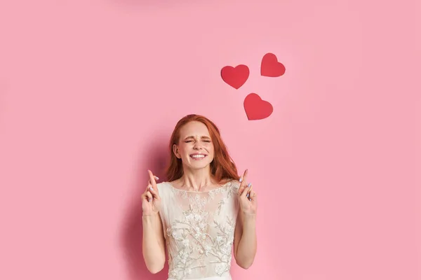 Positive female with red hair on pink background — Stock Photo, Image