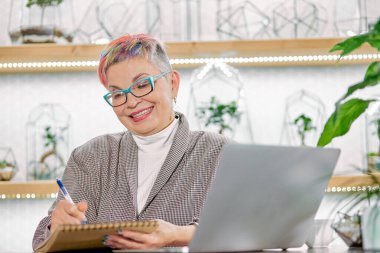 Good-looking elderly business woman with smiling look