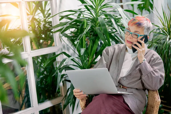 Empresária feliz sentado no centro de negócios com laptop e smartphone — Fotografia de Stock
