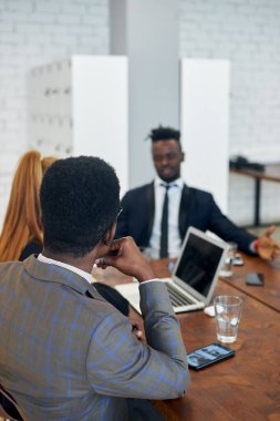 International group of business people having board meeting in modern office