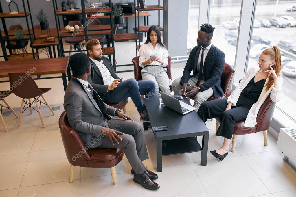 International group of business people having board meeting in modern office