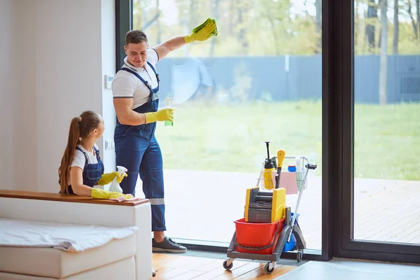 Young professional cleaners cleaning new house — Stock Photo, Image