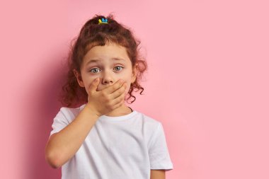 Yawning little girl isolated over pink background clipart