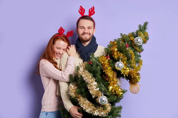 Happy couple in festive room at christmas tree