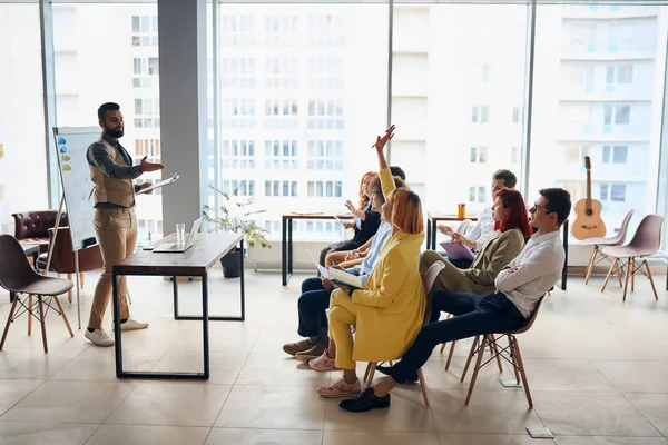 Experienced young business coach giving presentation to executive managers team — Stock Photo, Image