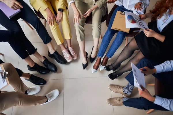 Diverse young people legs in circle