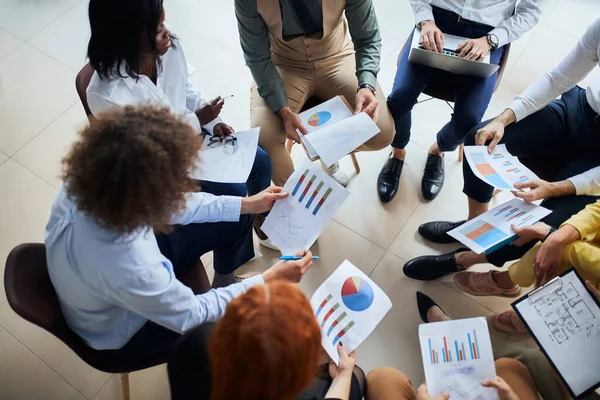 Diverse multi-etnische groep discssing business ideeën met behulp van diagrammen — Stockfoto