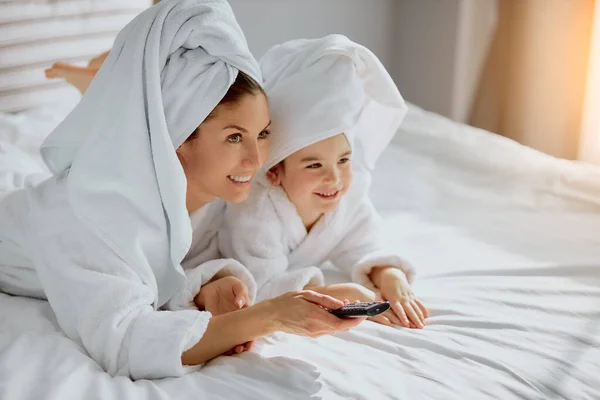 adorable parent and cute child watching tv