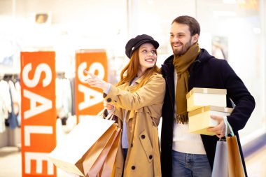 young husband and wife going to shop