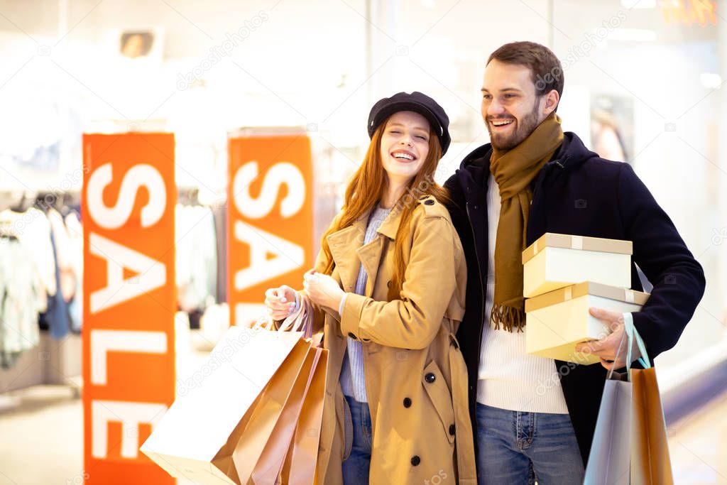 cheerful happy positive couple shopping