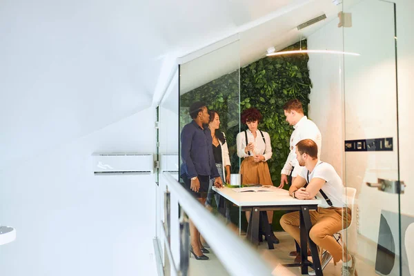 International team stand in office with green background — Stock Photo, Image