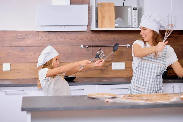 Ludique joyeuse femme et enfant fille profiter du temps de cuisson dans la cuisine — Photo