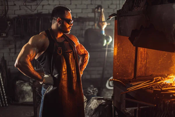 Young adult blacksmith man working — Stock Photo, Image