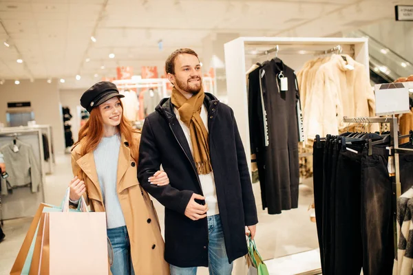 Hermosa esposa y marido caminan juntos en la tienda de ropa — Foto de Stock