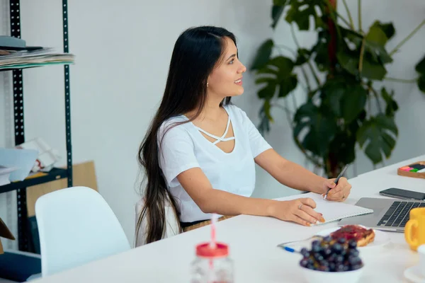 Cheerful, nice caucasian young woman in modern light office