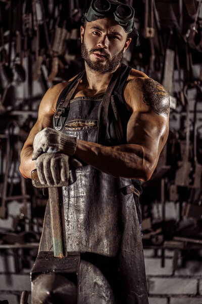 portrait of confident young blacksmith looking at camera