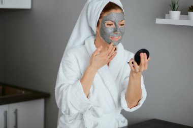 Yüzünde maske olan beyaz bir kadın.
