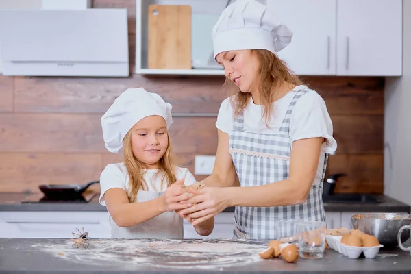 little girl help mother to make dough