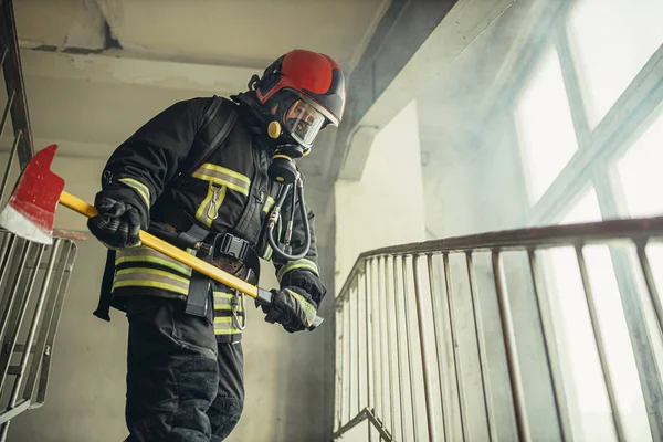 fireman with hammer at work