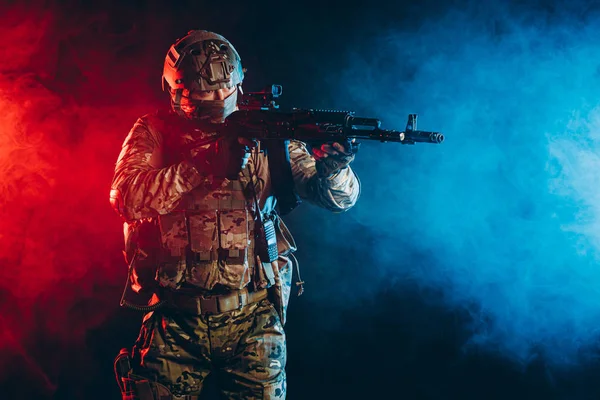 soldier man in uniform pointing rifle isolated over smoky space