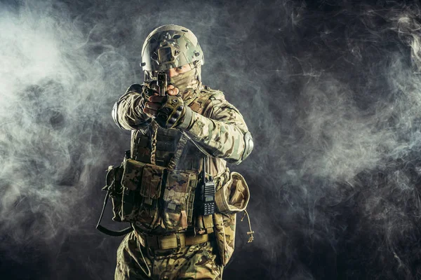 Portrait of young caucasian soldier with rifle — Stock Photo, Image