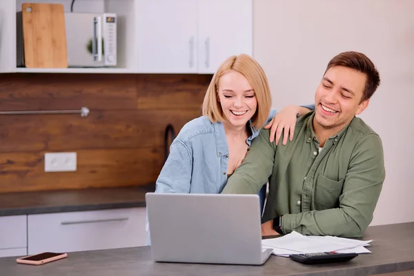 Encantador casal positivo verificando suas finanças em casa — Fotografia de Stock