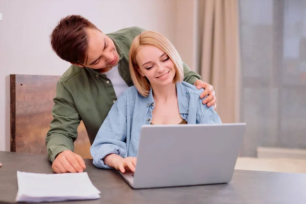 Animado jovem homem e mulher usar laptop em casa — Fotografia de Stock
