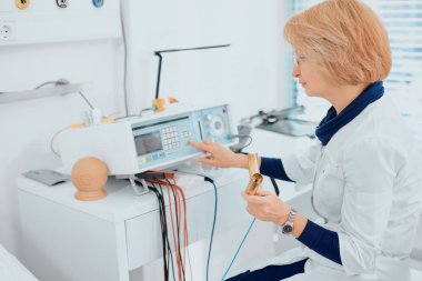 Profesyonel doktor iş yerinde tıbbi cihaz kullanıyor.