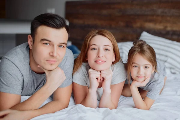 Familia caucásica amigable en la cama — Foto de Stock