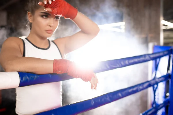 weary fit woman in ring