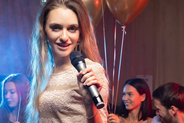 portrait of beautiful blond woman in karaoke bar