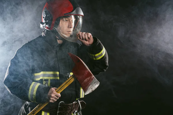 Handsome strong fireman with hammer — Stock Photo, Image