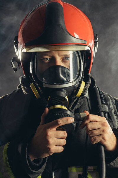 portrait of handsome brave firefighter in studio